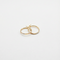 Gold hoop earrings on a light gray background