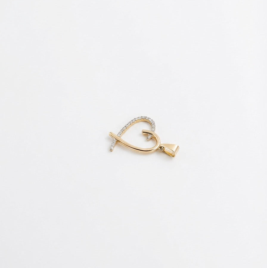 Gold earring on a light gray background