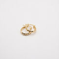 Gold hoop earrings on a light gray background