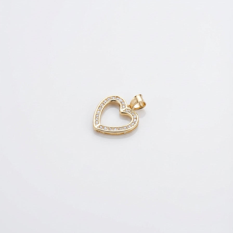 Gold heart-shaped pendant with embedded stones on a light gray background