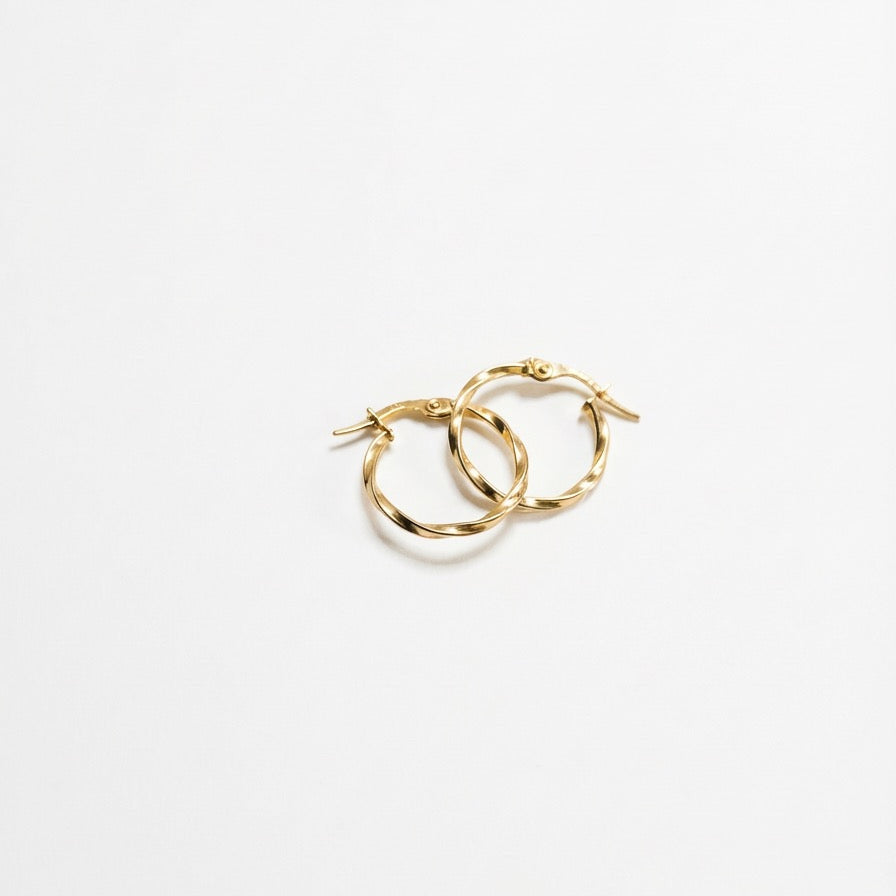 Gold hoop earrings on a white background